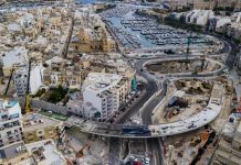 The final part of the iron structure that forms the Msida Creek flyover is fixed in place