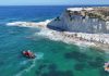 Three people and dog rescued from rough seas